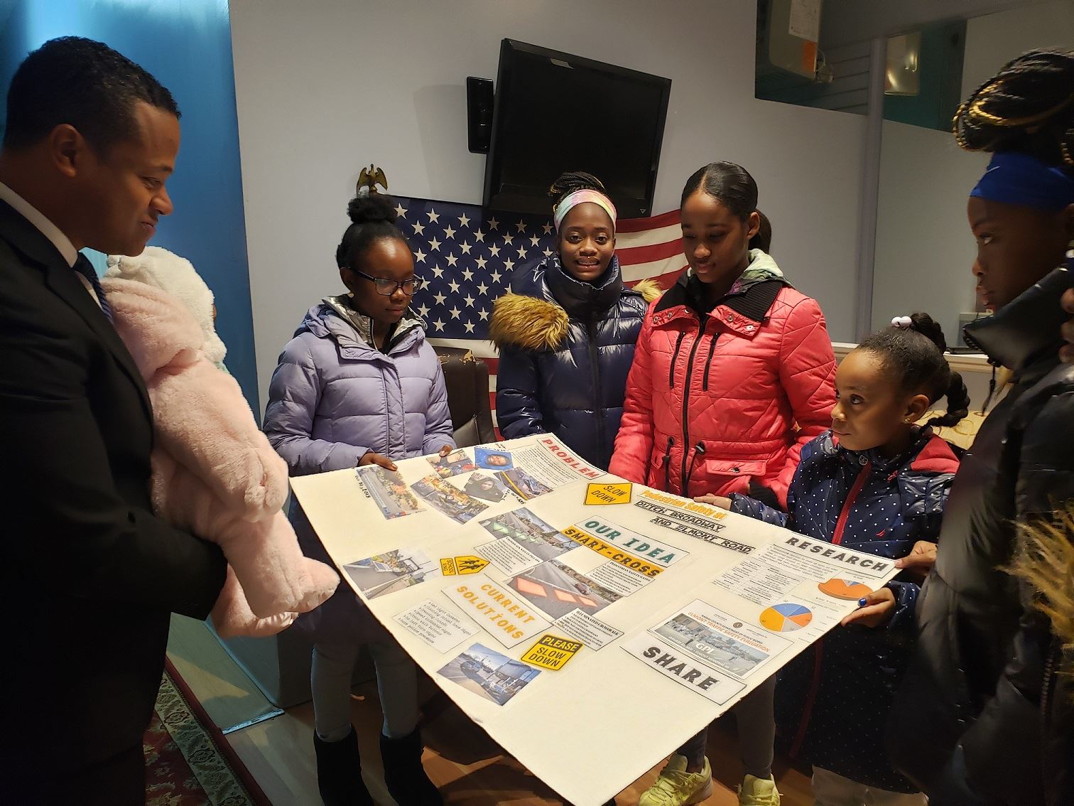Legislator Solages discusses a Dutch Broadway traffic safety proposal with young people from Elmont during a community meeting earlier this year.